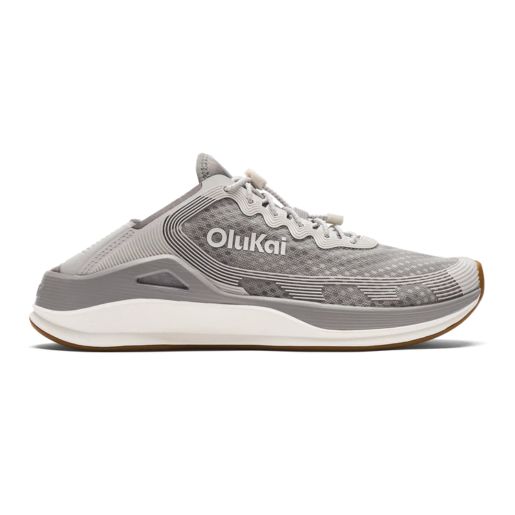 Gray sneaker with 'OluKai' branding on a white background