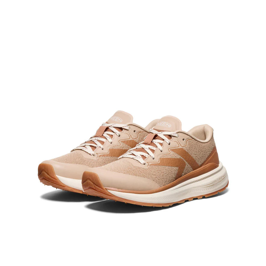 Pair of beige and brown sneakers on a white background