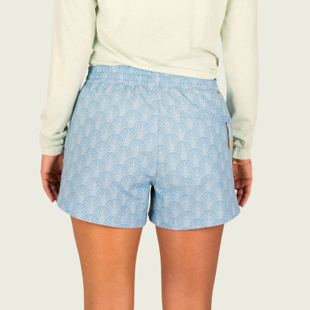 Light blue patterned shorts worn by a person on a white background