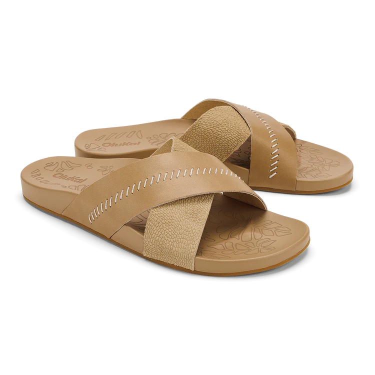 Pair of tan sandals with criss-cross straps on a white background
