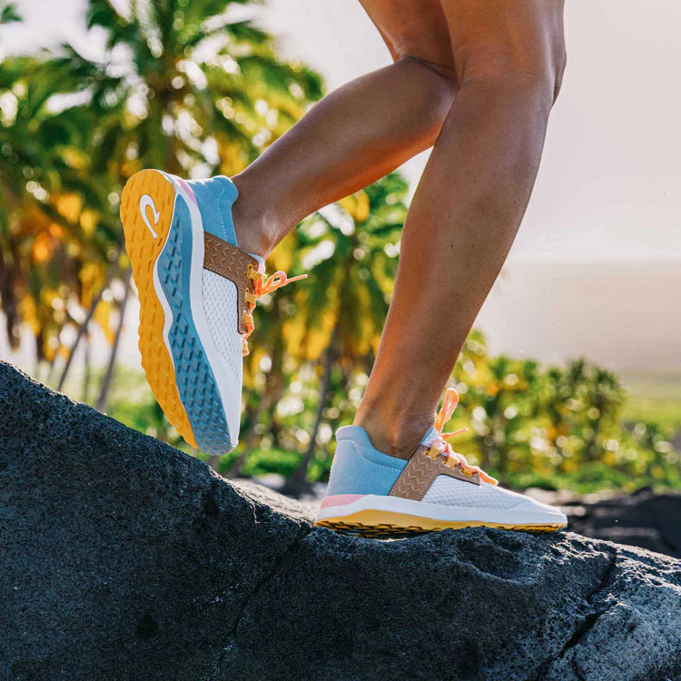 Person wearing colorful running shoes on a rock with a natural background
