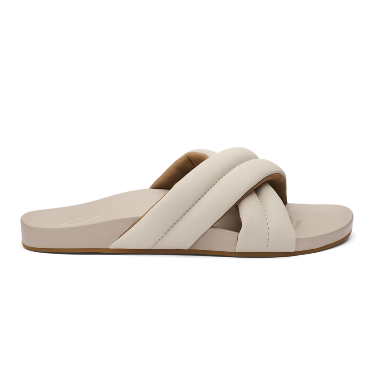 Beige sandal with criss-cross straps on a white background