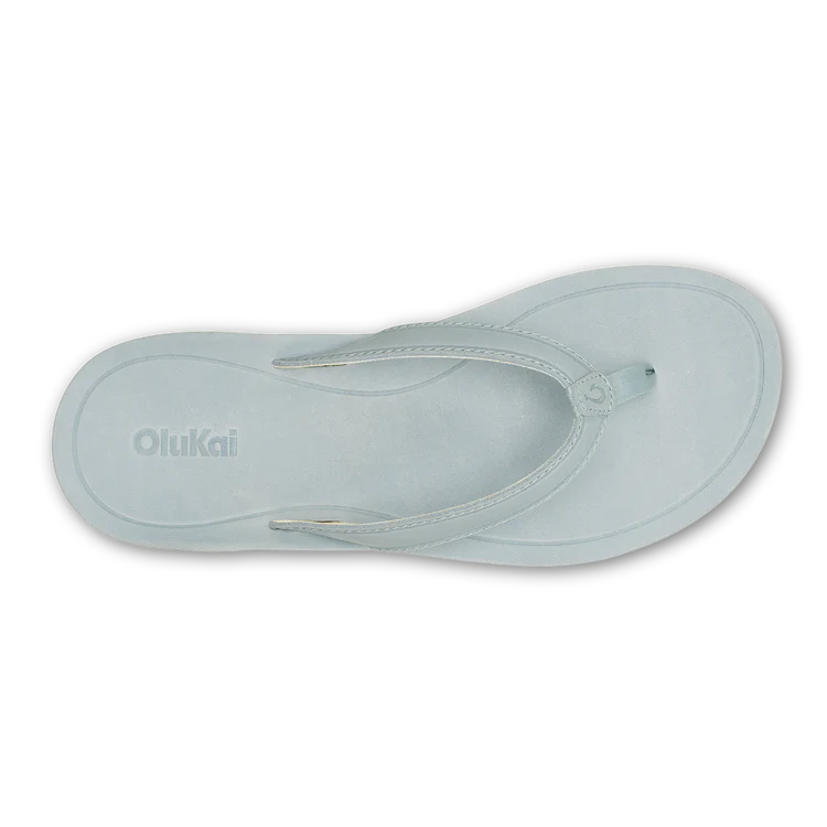 Light blue sandal with 'Olukai' branding on a white background