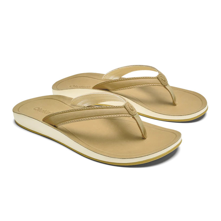 Pair of beige sandals on a white background