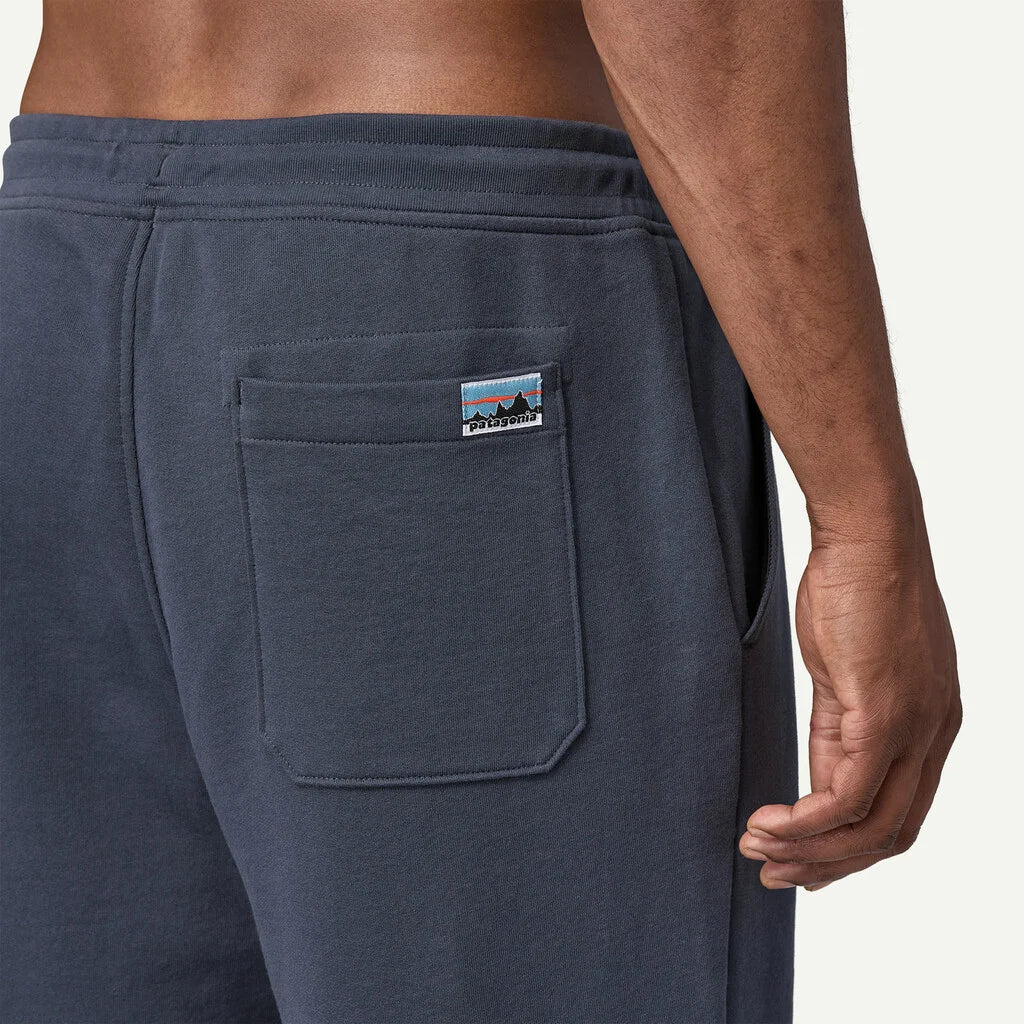 Navy blue sweatpants with a brand logo on the pocket against a white background