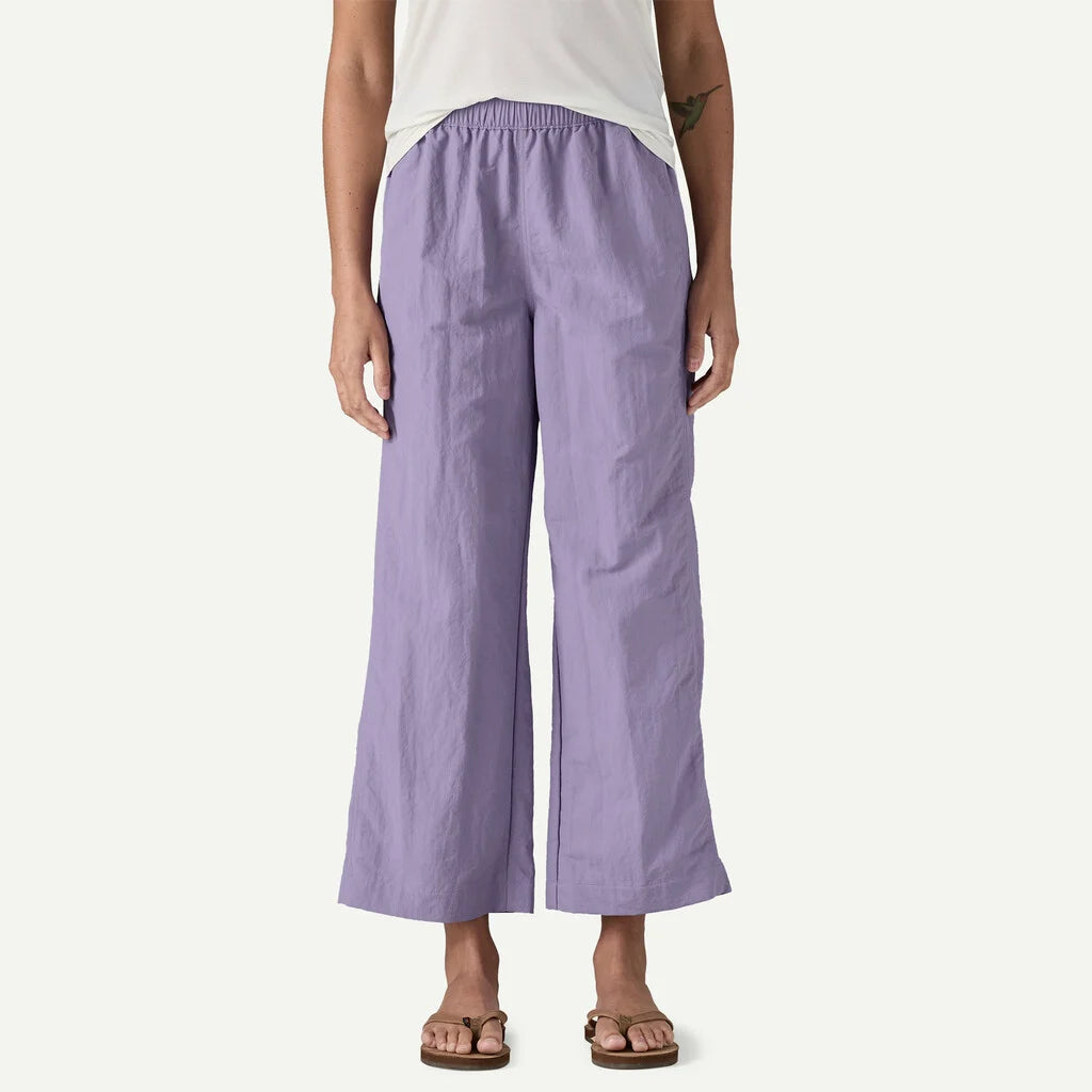 Person wearing light purple wide-leg pants on a white background