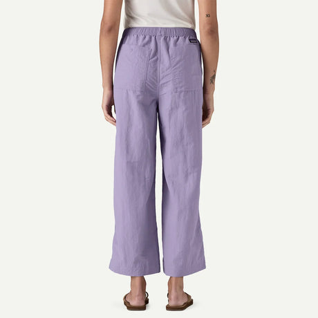 Person wearing light purple pants on a white background