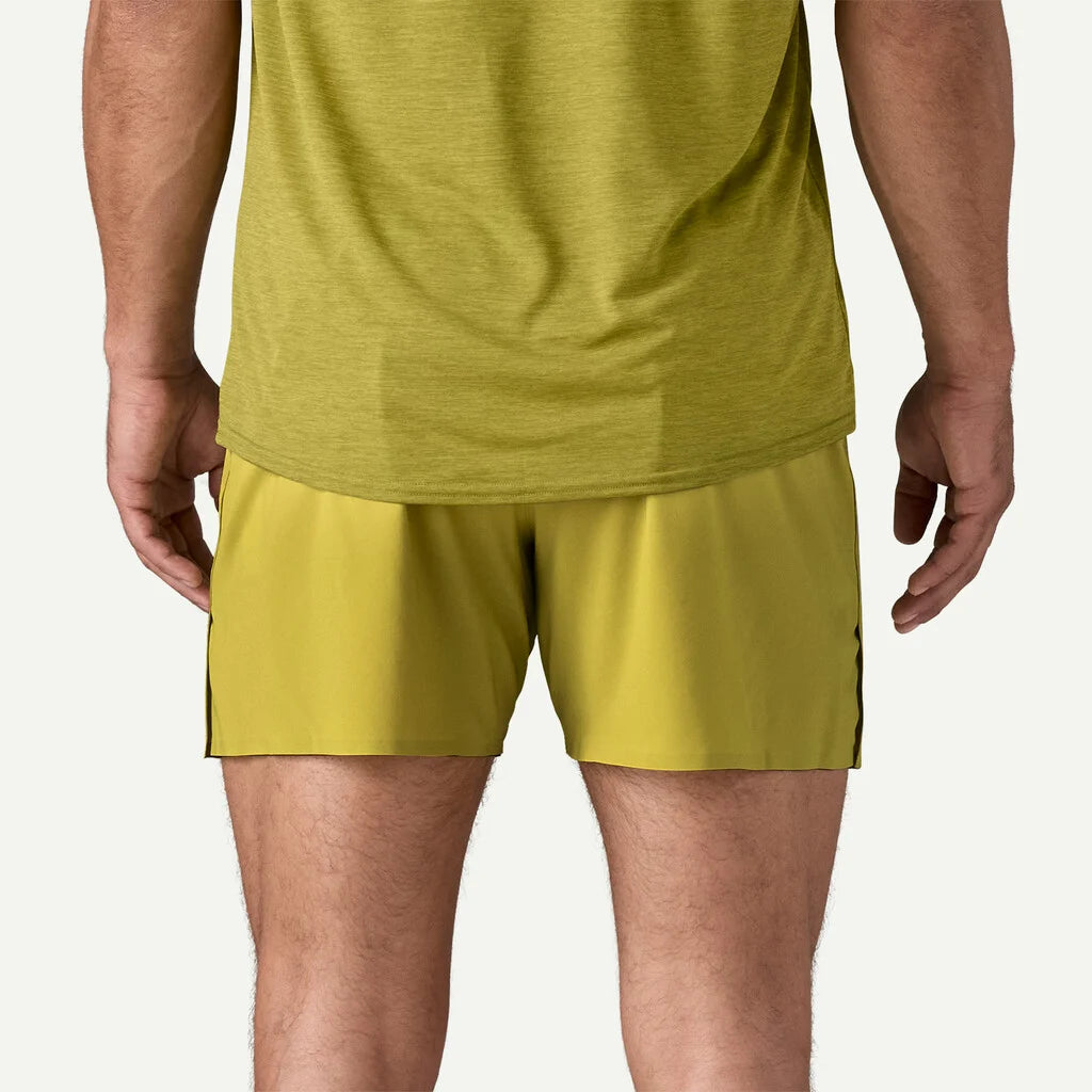 Person wearing a green athletic outfit on a white background
