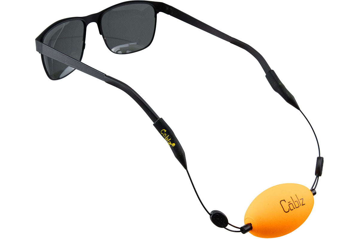 Sunglasses with an orange Cabelz eyeglass holder on a white background