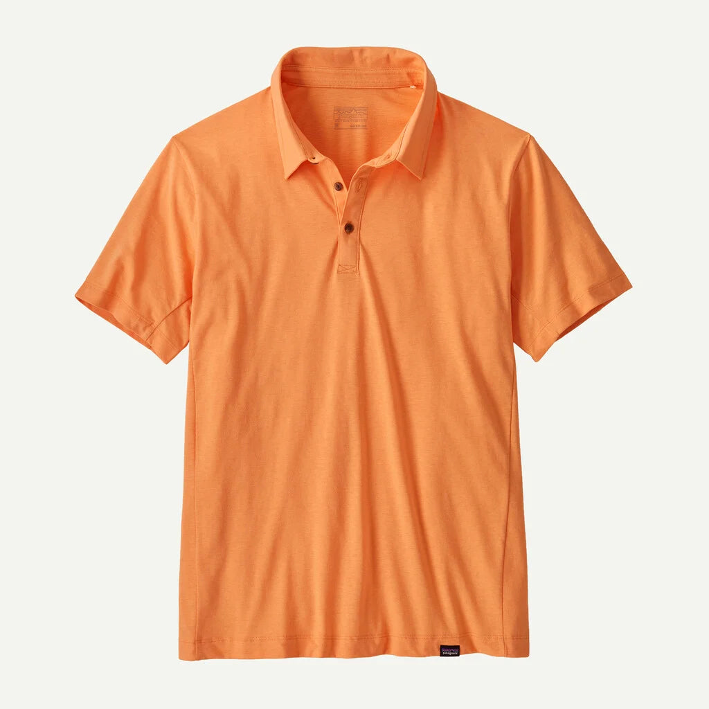 Orange polo shirt on a light beige background