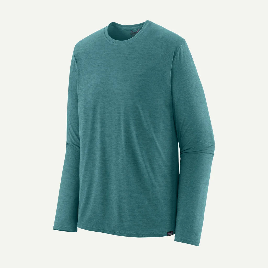 Teal long-sleeve shirt on a light gray background