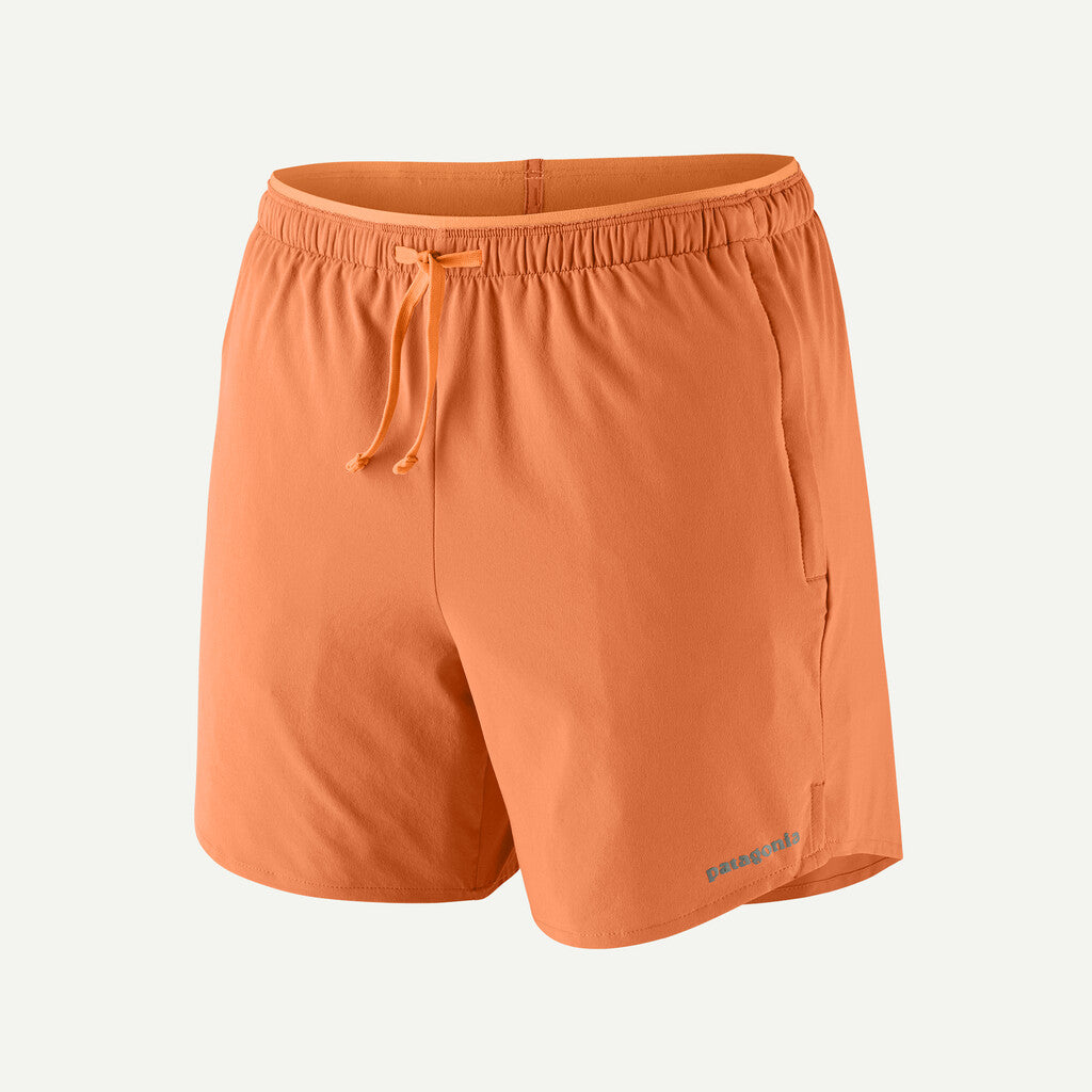 Orange shorts with a drawstring on a light gray background