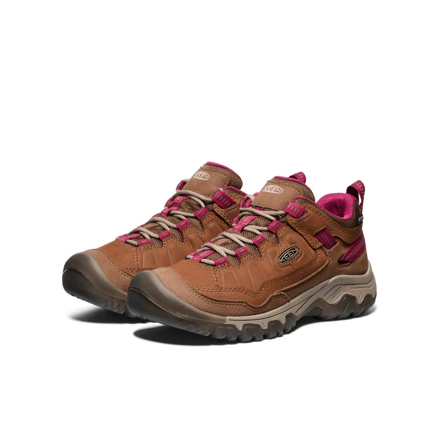Pair of brown and pink hiking shoes on a white background