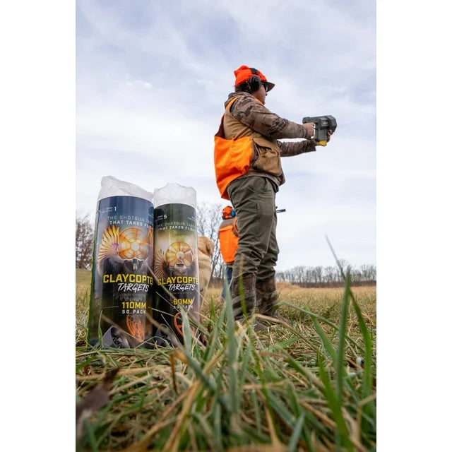 Hunters in a field with Claymore Traps packaging in the foreground