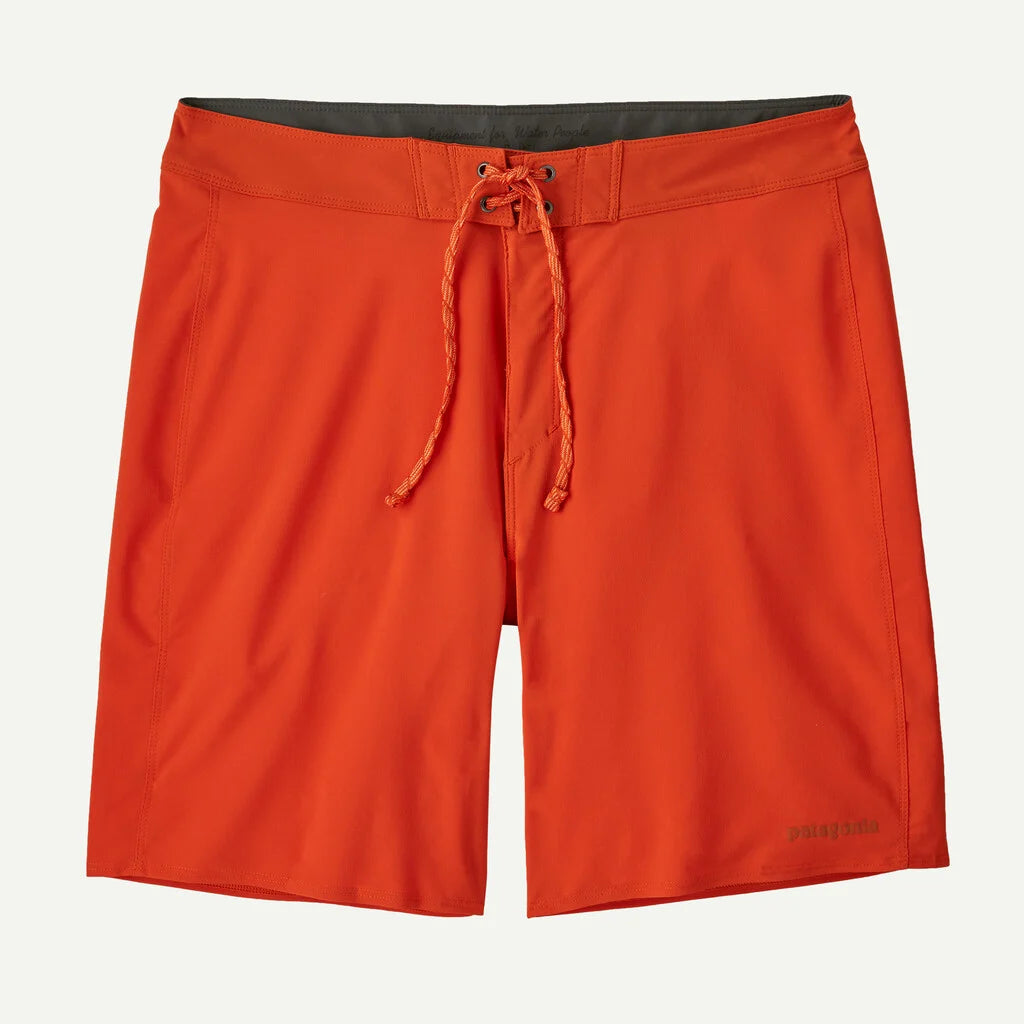 Orange shorts with a drawstring on a light gray background