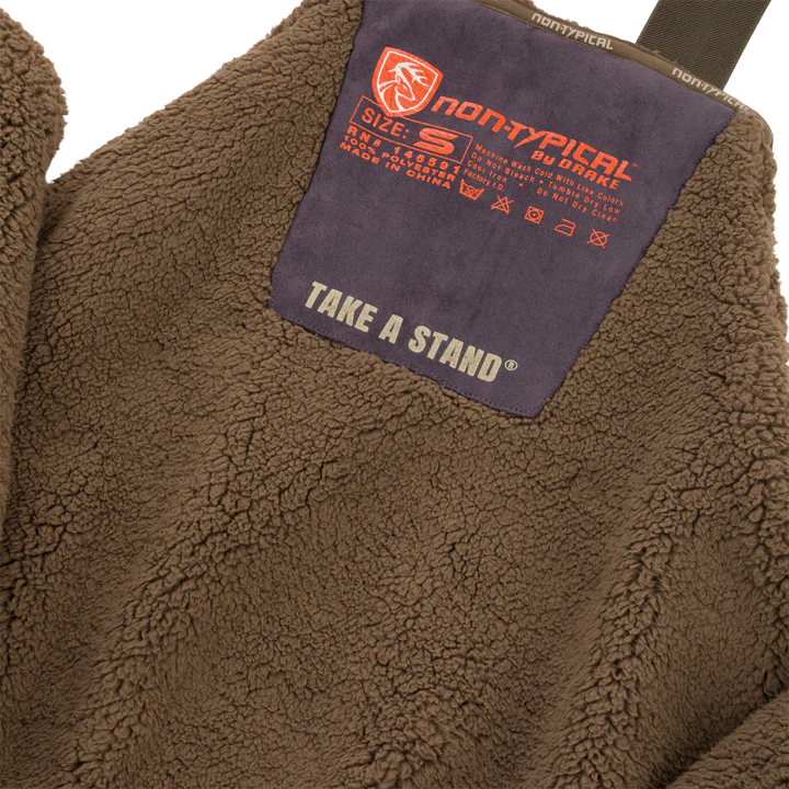 Brown fleece jacket with a 'non-typical' brand label on a white background