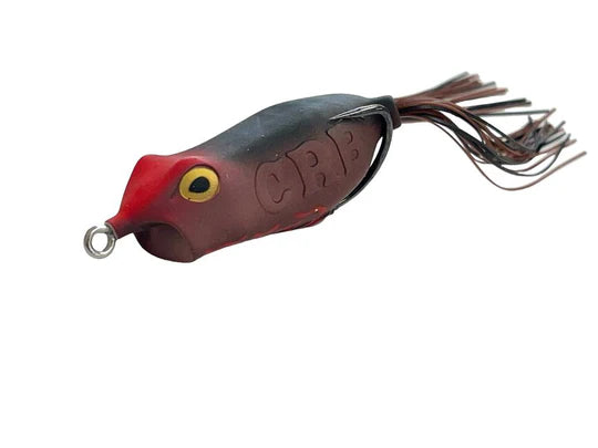 Fishing lure with red and black details on a white background