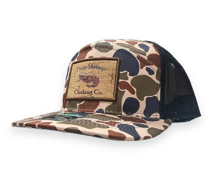 Camouflage trucker hat with a patch on a white background