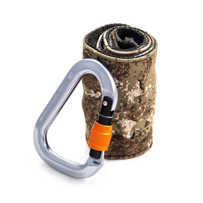 Carabiner with orange clip and camouflage-patterned mat on a white background