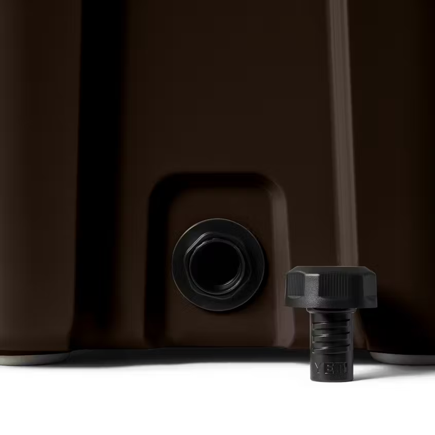 Close-up of a brown container with a black valve and cap on a white background