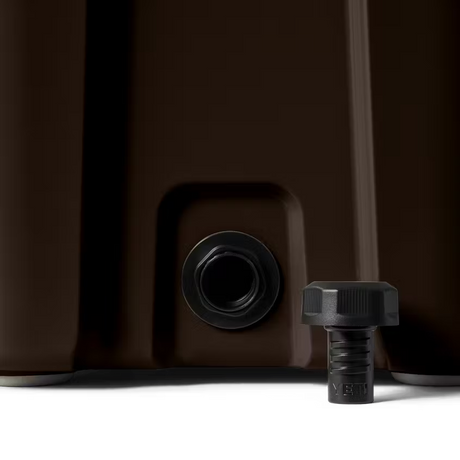 Close-up of a brown container with a black valve and cap on a white background