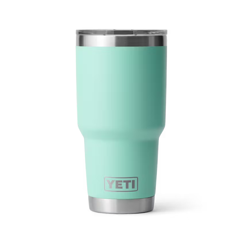 Turquoise YETI tumbler with a silver rim on a white background