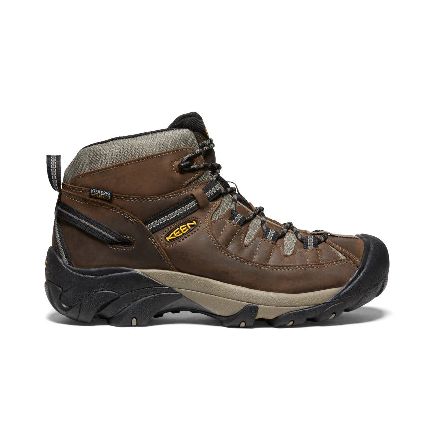 Brown hiking boot with black sole on a white background