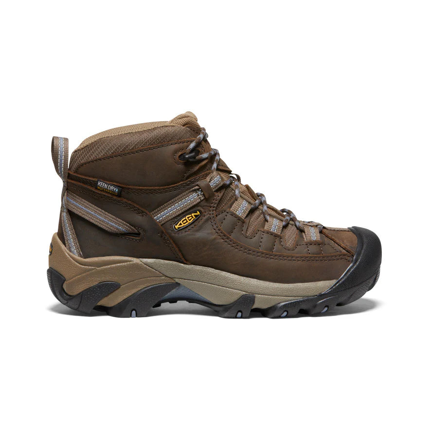 Brown hiking boot with visible Keen logo on a white background