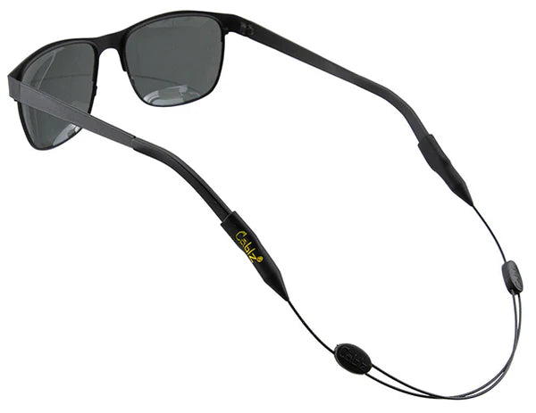 Sunglasses with a black cord attached on a white background