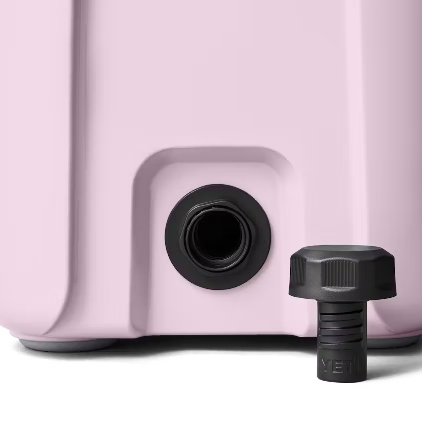 Close-up of a pink container with a black valve and cap on a white background