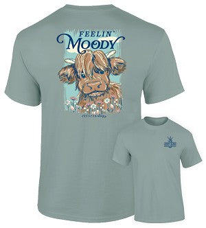 Light blue t-shirt with a graphic of a cow with braids and flowers, and text 'Feelin Moody', on a white background.