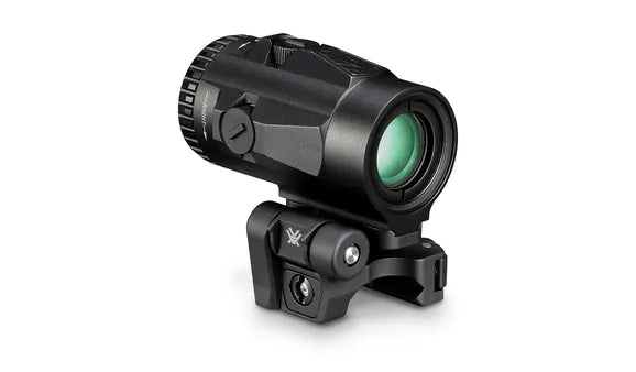 Black tactical sight with green lens on a white background