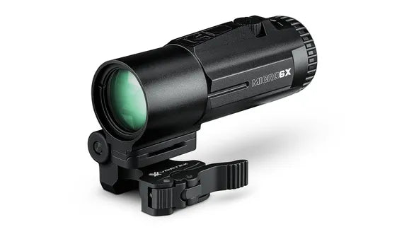 Black monocular with green lens on a white background