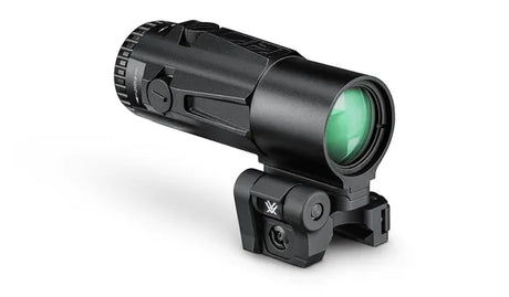 Green-tinted rifle scope with black mount on a white background