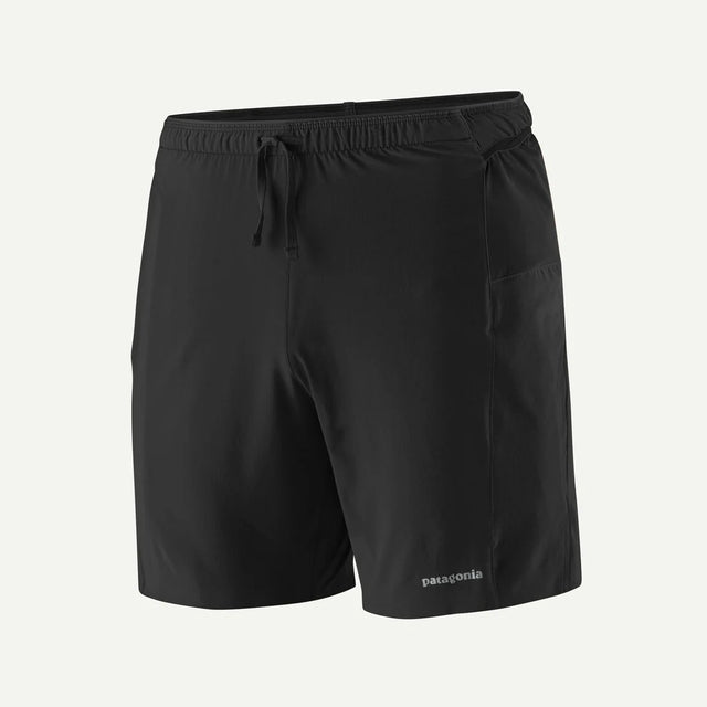 Black shorts with a drawstring on a light gray background