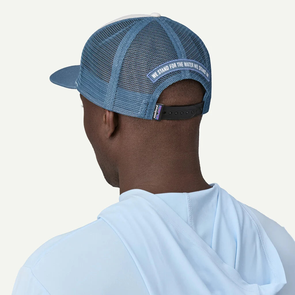 Person wearing a blue mesh cap with text on the back against a white background