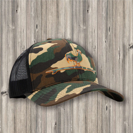 Camouflage baseball cap with mesh back on a wooden background