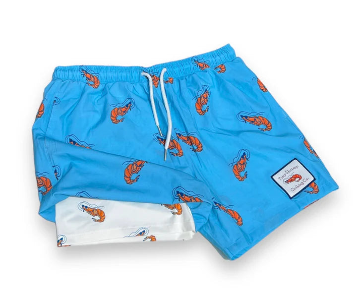 Blue swim shorts with orange lobster pattern on a white background