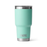 Turquoise YETI tumbler with a silver rim on a white background