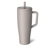 Beige mug with handle and straw lid on a white background