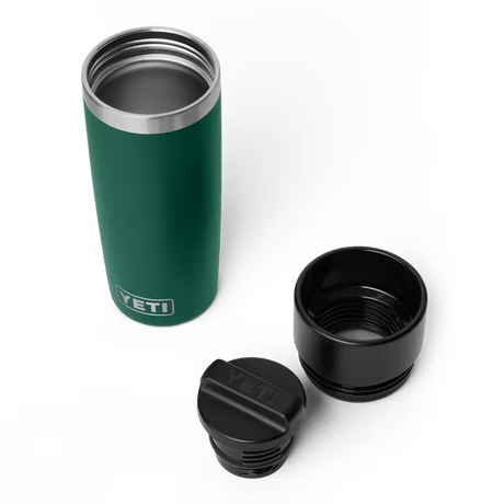 Green YETI insulated mug with two black lids on a white background